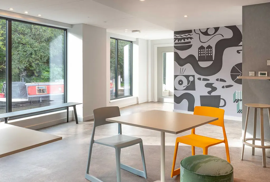 Canal-side communal interior with contemporary furniture and a graphic mural, Boulevard Wharf, Nottingham