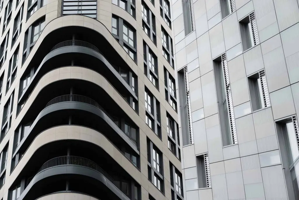 Curved balconies and stone facades of contemporary apartment buildings in Spitalfields, London